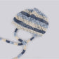Close-up of Haila hollow out lace up knit slouchy beanie showing knit texture and lace-up detail