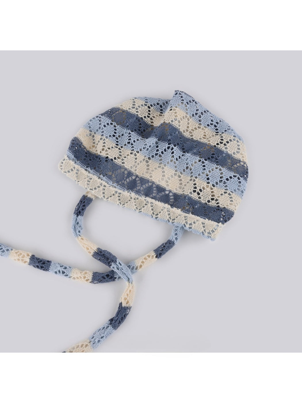 Close-up of Haila hollow out lace up knit slouchy beanie showing knit texture and lace-up detail