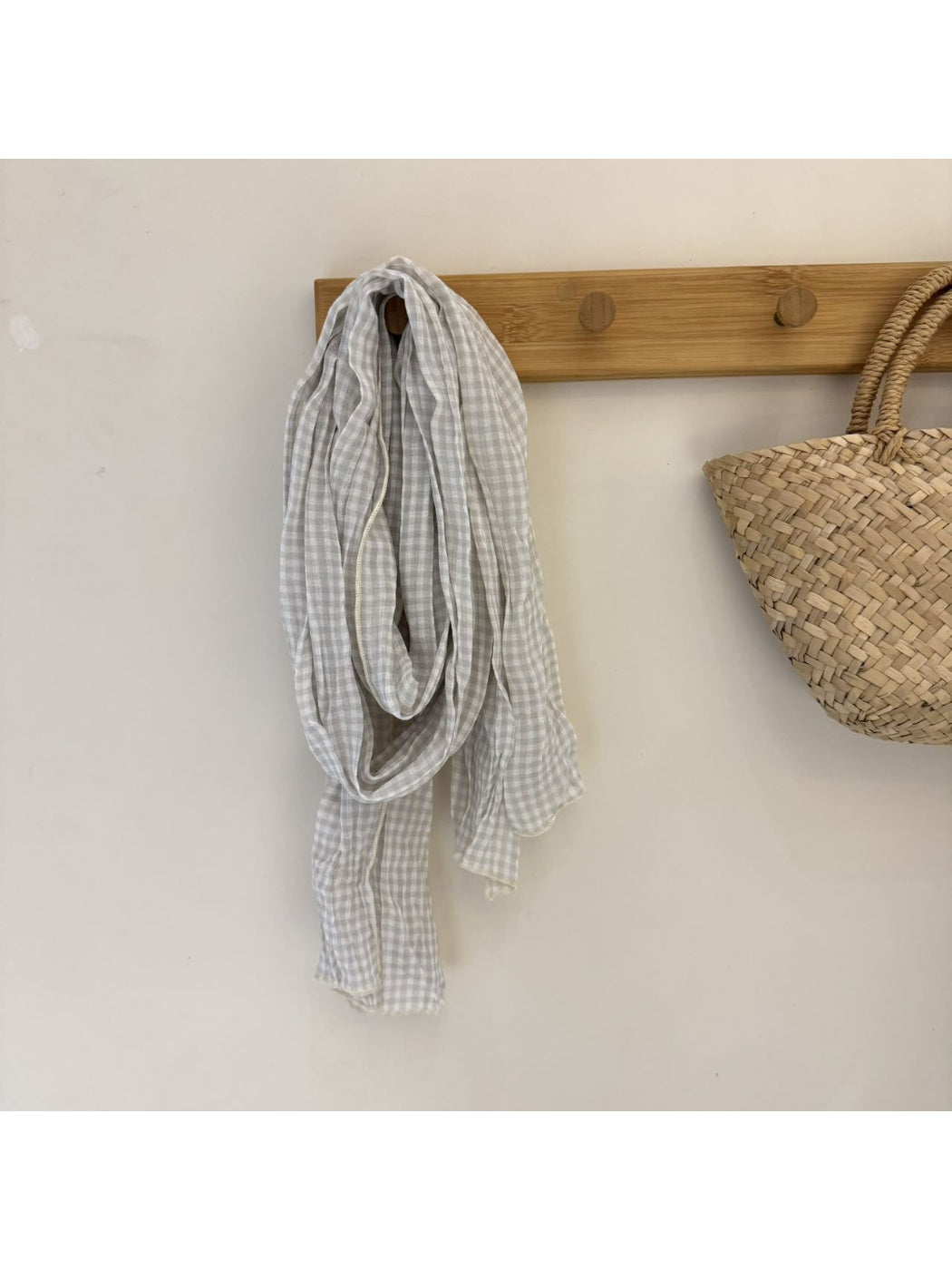 Folded black and white gingham scarf highlighting soft material and pattern
