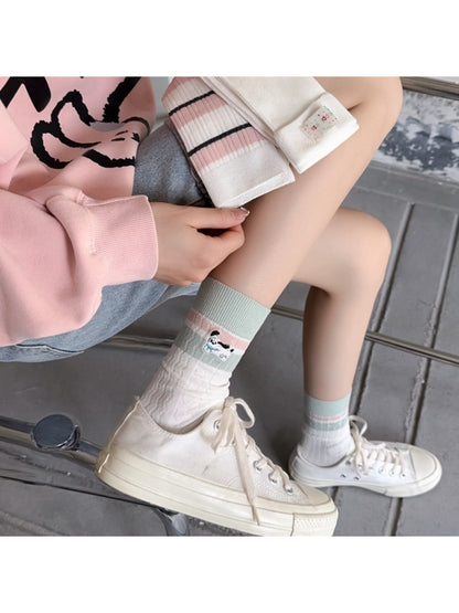 Rufia crew socks worn on feet, highlighting comfortable fit and vibrant stripe design