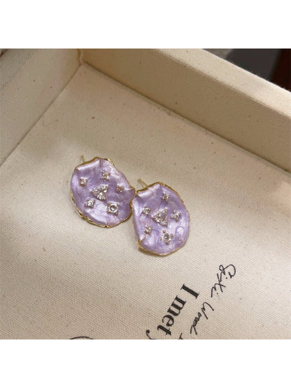Earwish floral stud earrings arranged with soft pastel flowers for styling