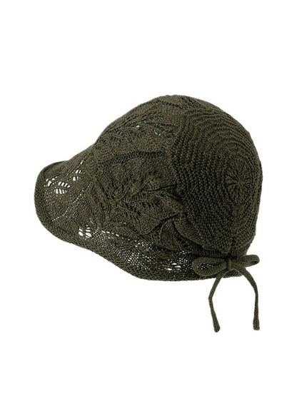 Model wearing Haila open knit tie back hat in beige, front angle