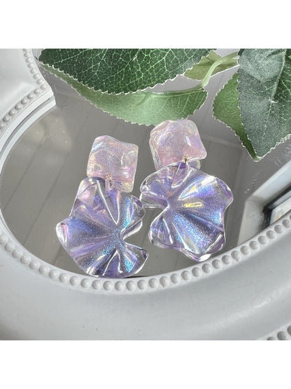 Earwish purple flower drop earrings displayed on a white jewelry stand