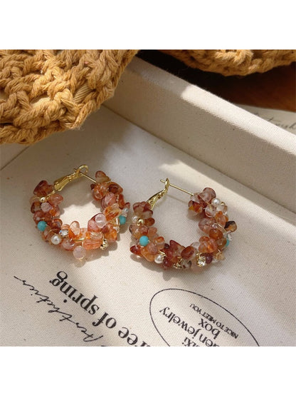 Side view of light tone floral hoop earrings showing detailed flower design
