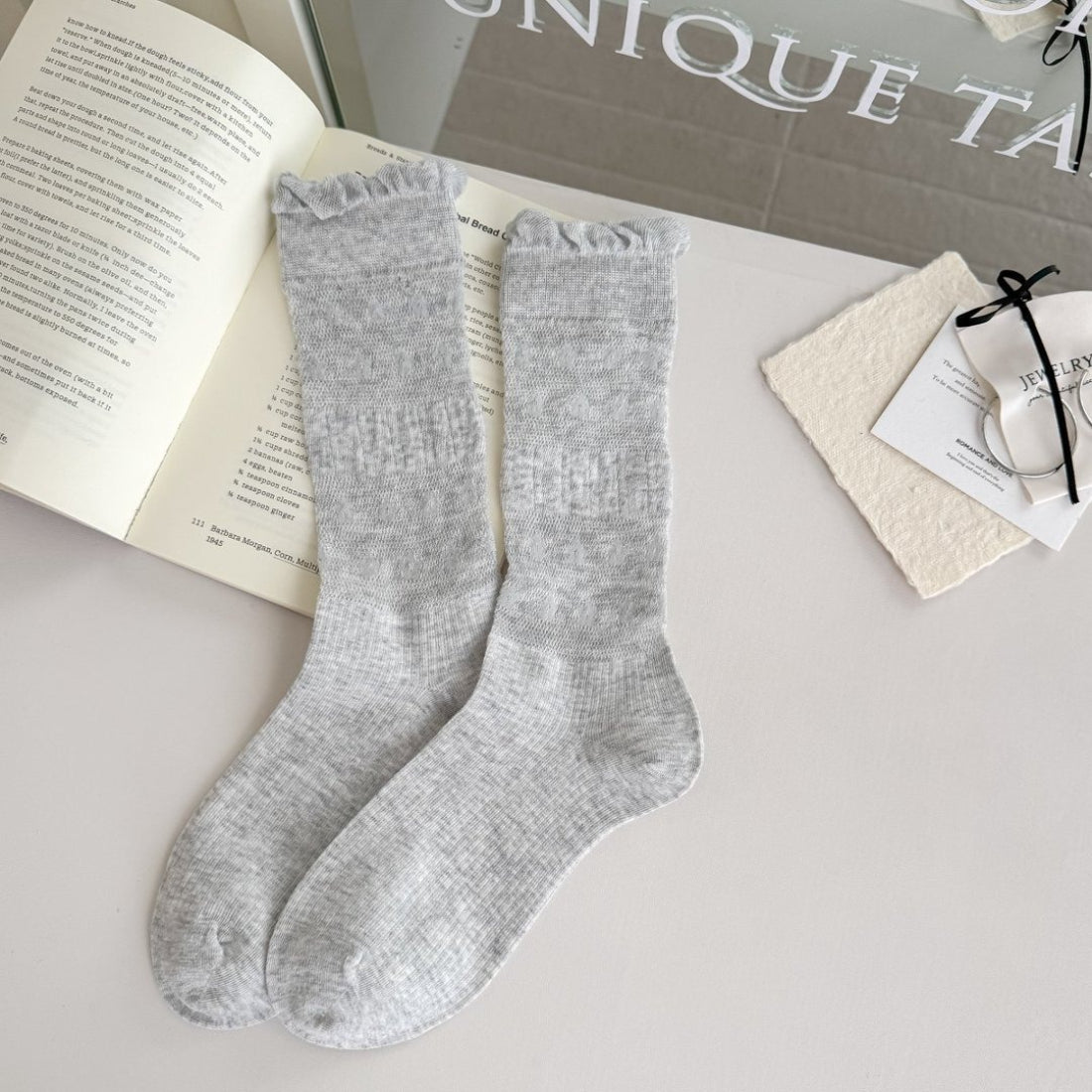 Rufia floral trim ribbed crew socks worn on feet with visible floral embroidery and ribbed fabric