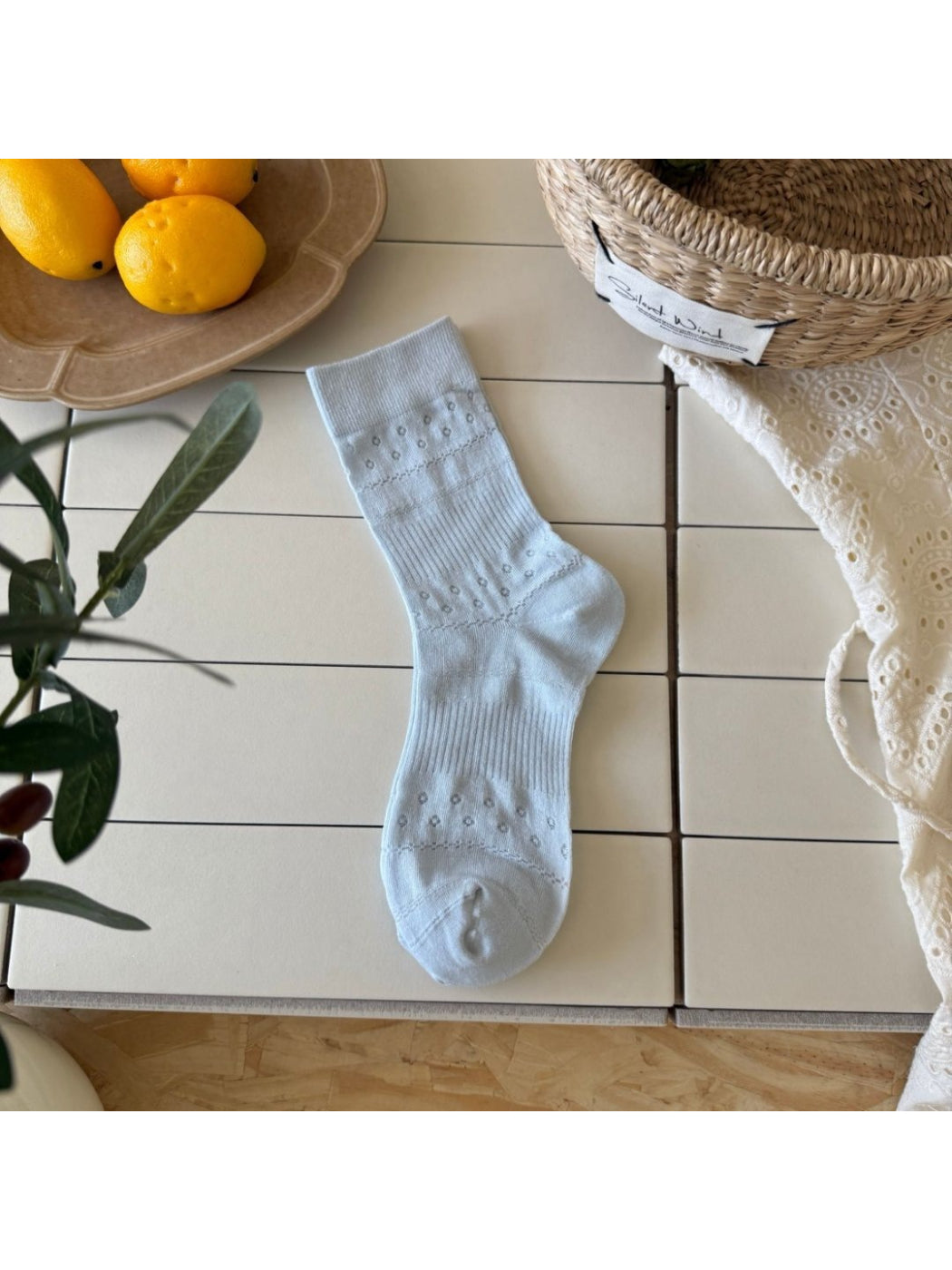 Rufia Dot Floral mid-calf socks worn on feet showing fit and pattern