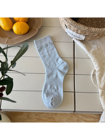 Rufia Dot Floral mid-calf socks worn on feet showing fit and pattern