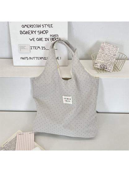 Cosbai soft polka dot shoulder tote bag hanging with visible shoulder strap and dots