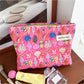 Close-up of Cosbai pink shell makeup pouch showing its curved silhouette and soft pink color
