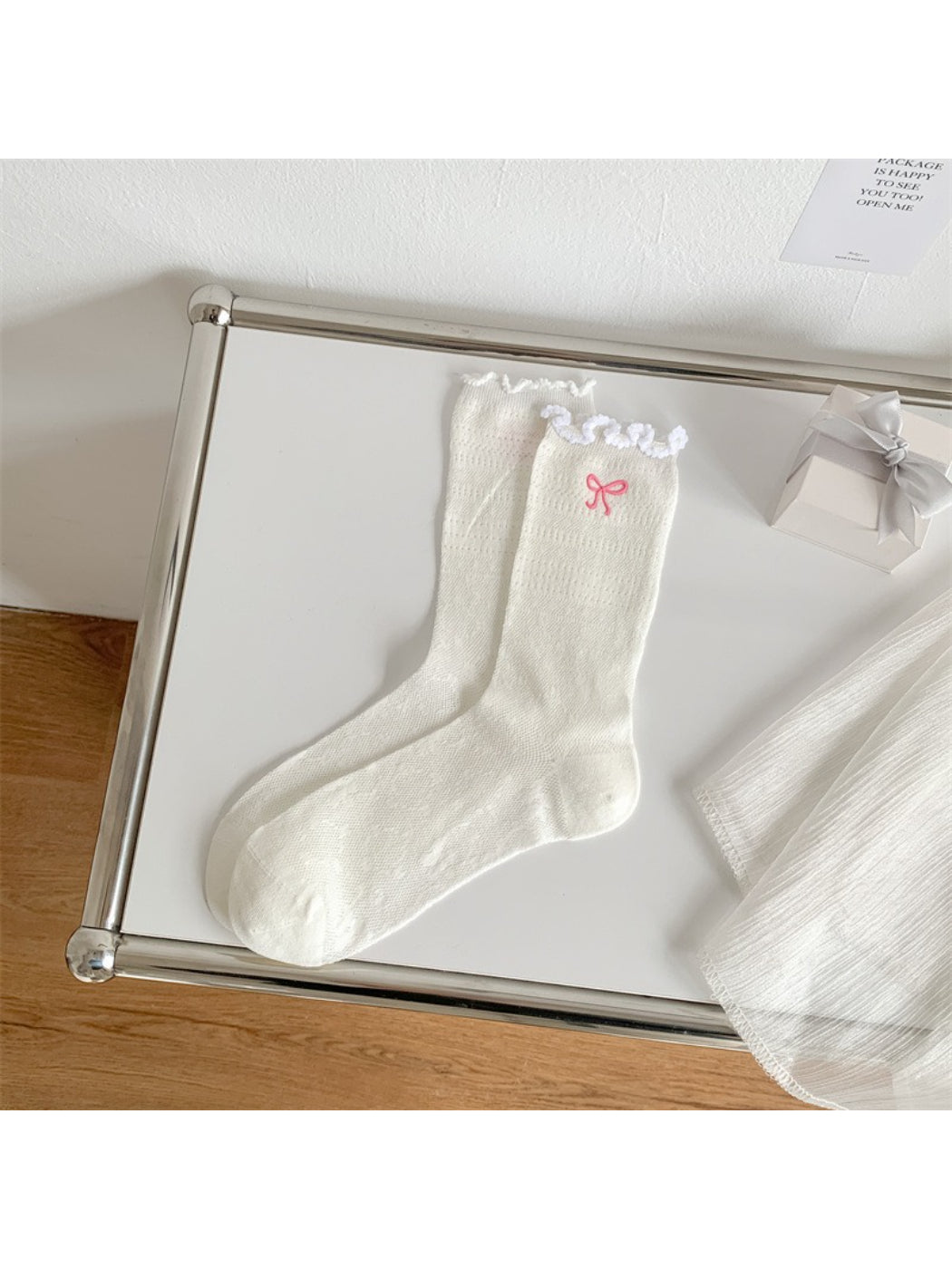 Rufia crew socks in pastel shade with decorative bow and ruffled lettuce edge detail