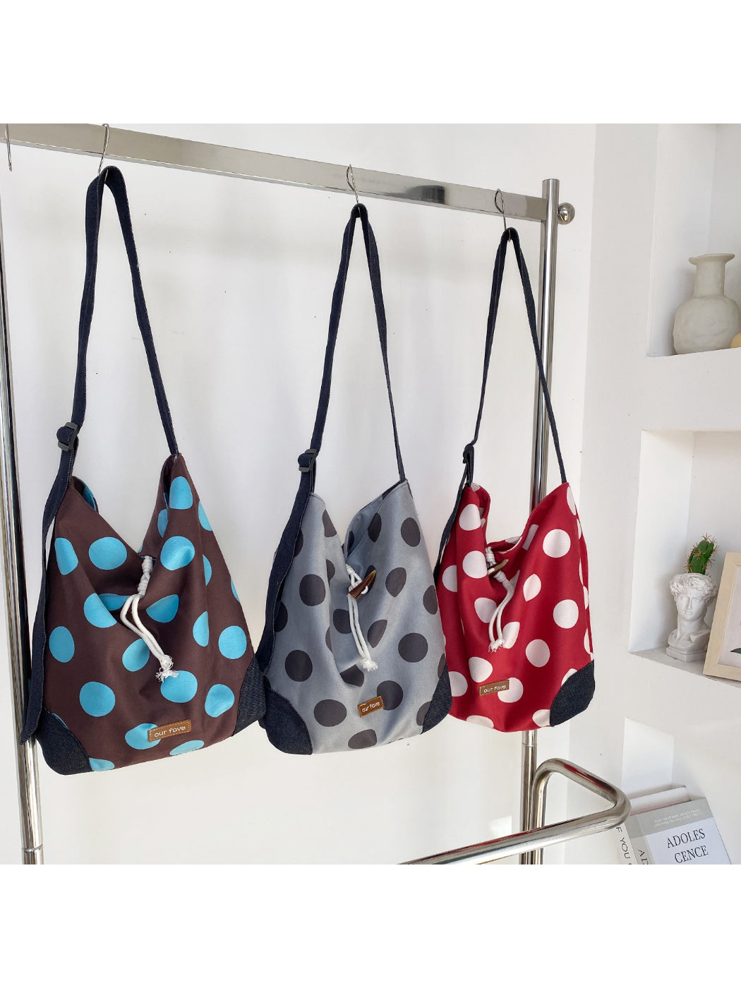 Side view of Cosbai polka dot drawstring crossbody bag showing strap and drawstring closure
