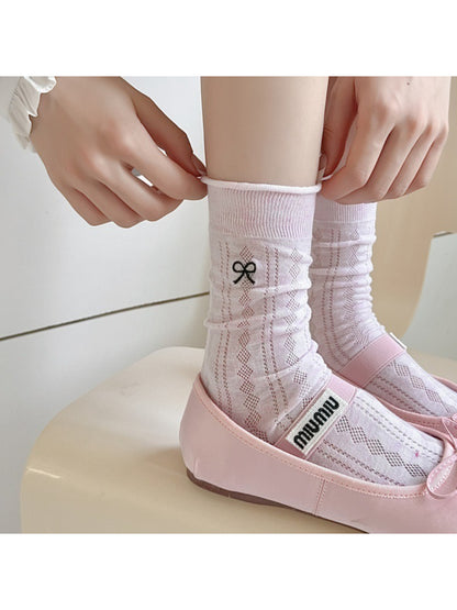 Pair of Rufia Tiny Ribbon Pointelle Socks in soft pink with delicate ribbon detail