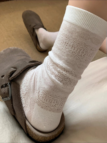 Side view of Rufia floral mid-calf socks worn, showing floral print and sock height
