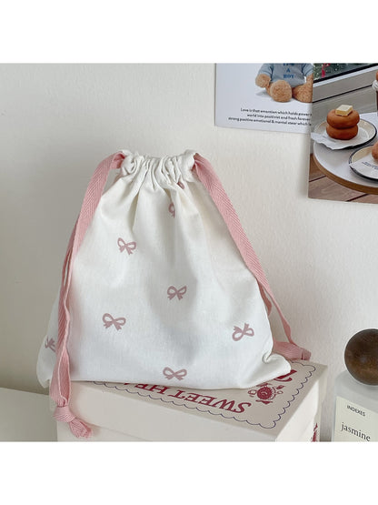Cosbai pouch with bow pattern displayed flat on surface