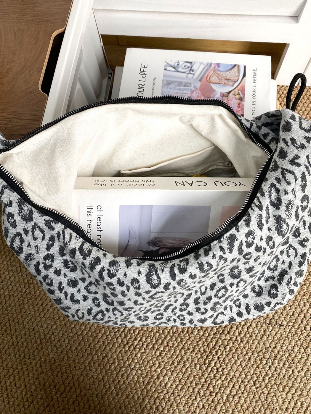 Cosbai leopard print slouchy shoulder bag styled with accessories on wooden surface
