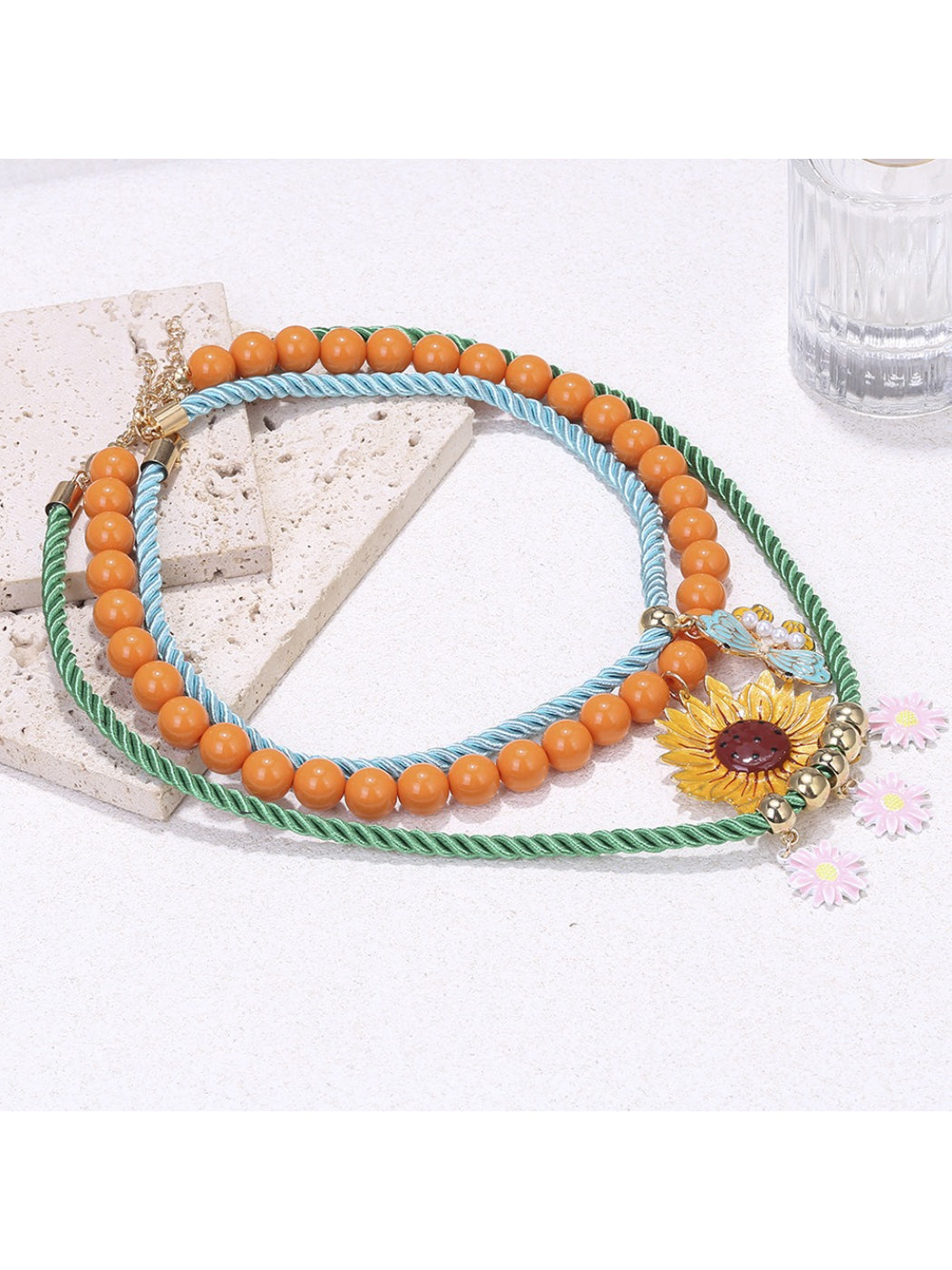 Neckit Sunflower Charm Rope Necklace displayed on a flat surface highlighting rope texture