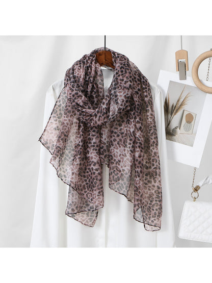 Model wearing the soft leopard pattern summer scarf styled around neck