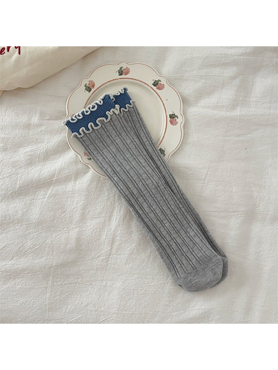 Rufia ruffle color block crew socks worn with shoes, showing ruffle detail above ankle