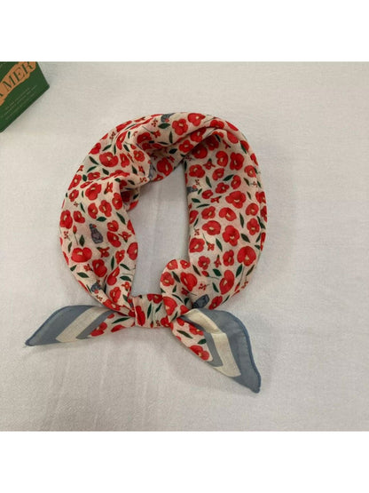 Scarvii Baroque Floral Square Scarf folded to display the detailed border design in gold and black
