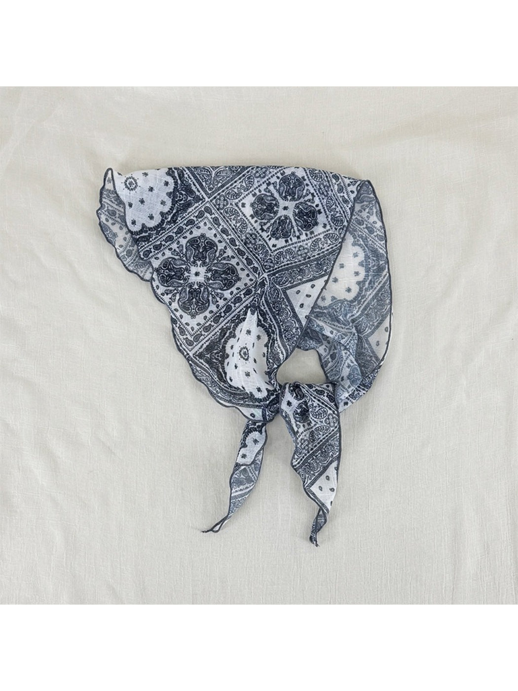 Soft paisley triangle head scarf displayed flat showing full pattern