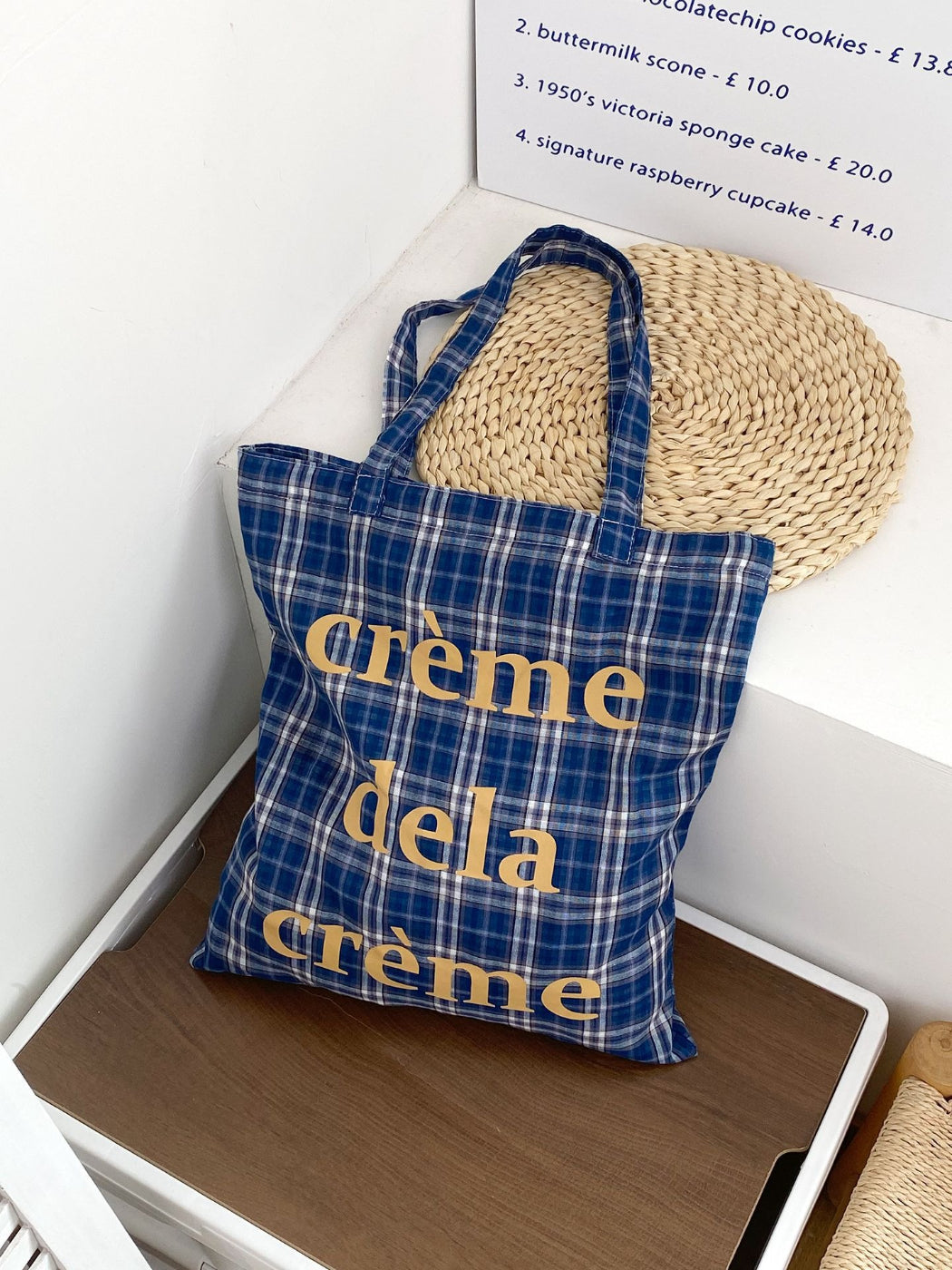 Cosbai plaid tote bag placed on wooden surface with lighting