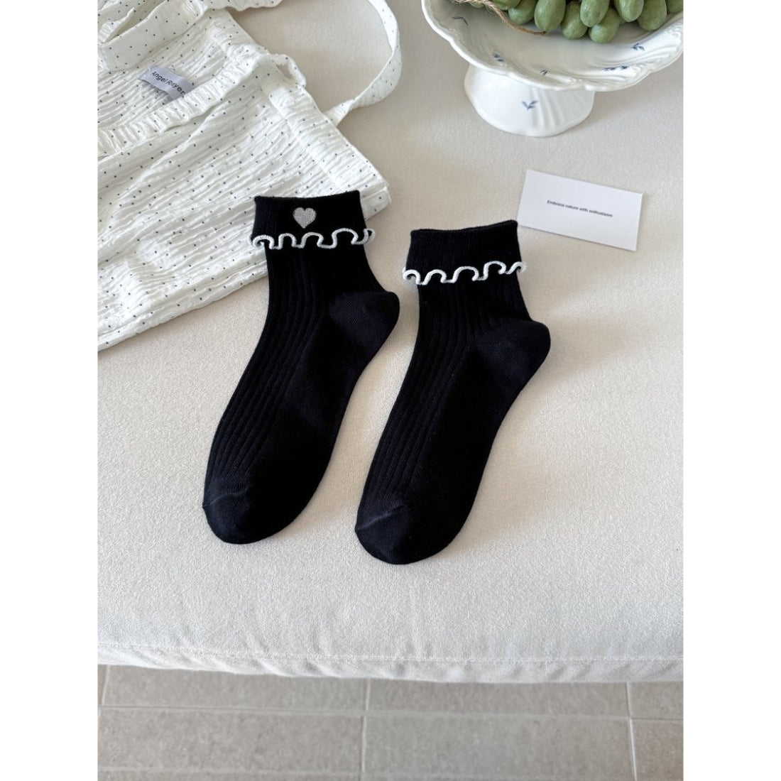 Model wearing Rufia soft lettuce cuff heart socks with casual outfit
