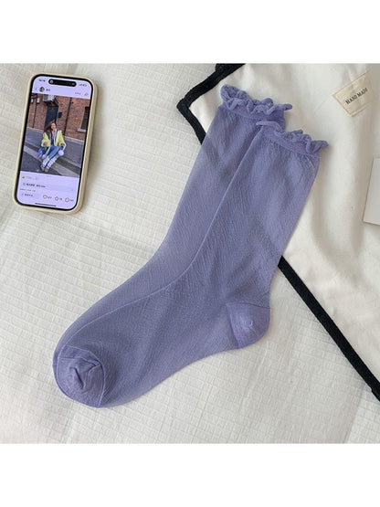 Rufia socks in soft sparkle fabric arranged in a fan shape on white background