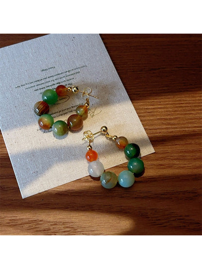 Close-up of Earwish multicolor beaded hoop earrings with vibrant small beads