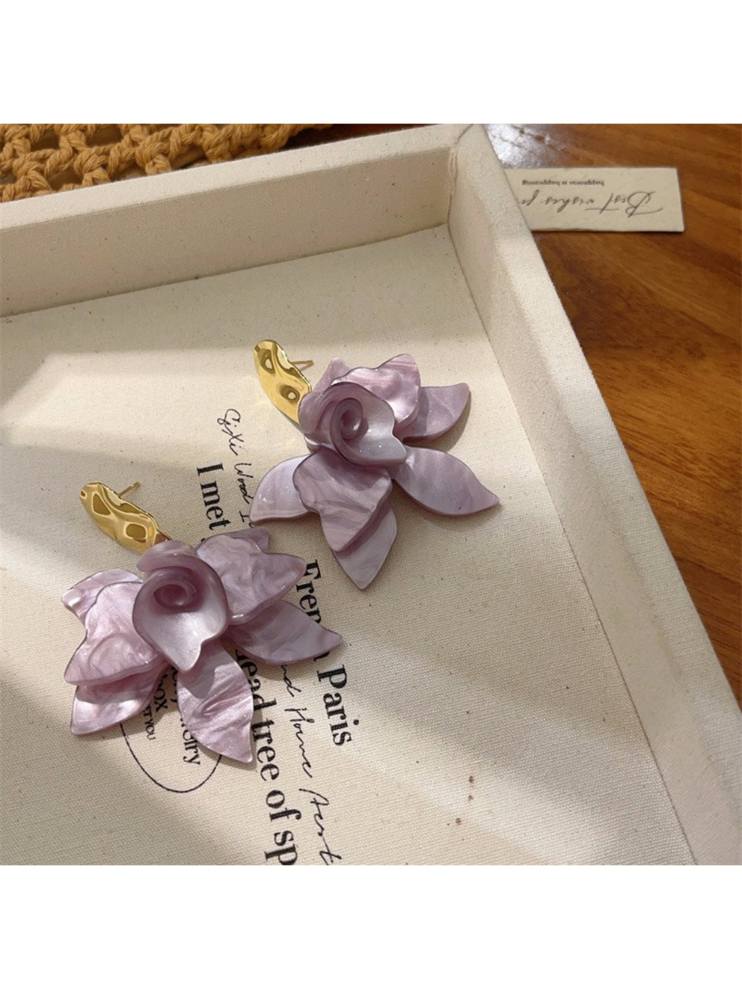 Earwish earrings photographed from above to show the full floral design
