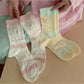 Pair of Rufia soft colourblock socks with heart design in pastel shades