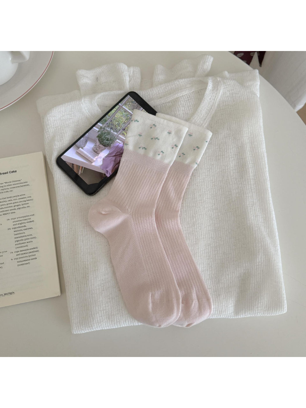 Flat lay of Rufia Dreamy Pastel Bloom crew socks displaying full pastel floral design