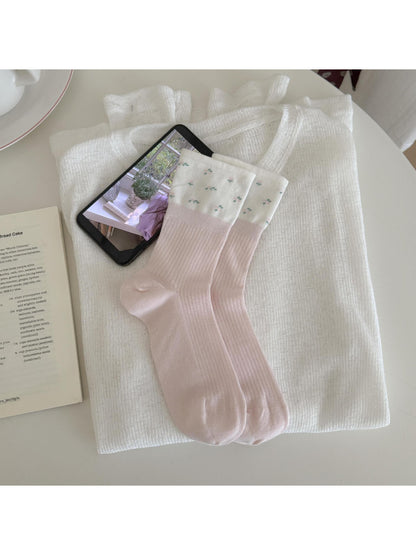 Flat lay of Rufia Dreamy Pastel Bloom crew socks displaying full pastel floral design