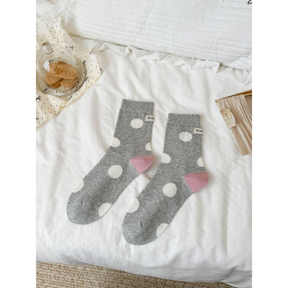 Close-up of fabric texture on Rufia socks with black dots and solid black heel
