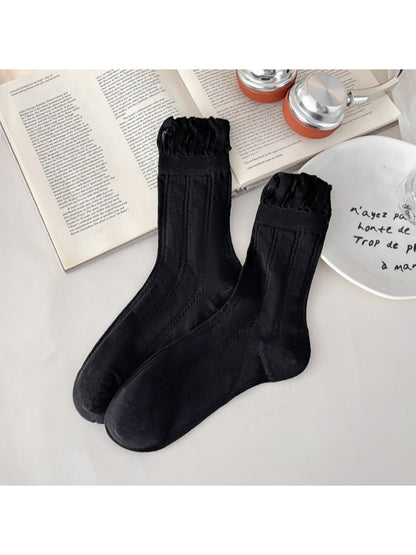 Rufia vintage pointelle crew socks in cream color paired with loafers