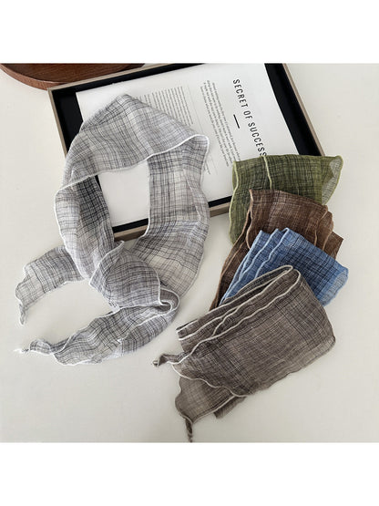 Close-up of soft textured fabric of skinny scarf in beige color