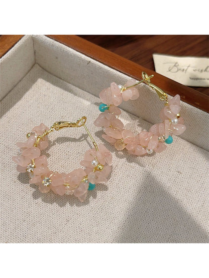 Earwish floral hoop earrings displayed on a jewelry stand