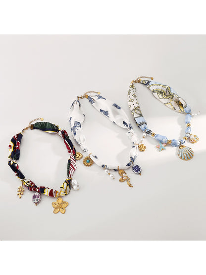 Close-up of Neckit Botanical Charm fabric necklace showing detailed floral charm