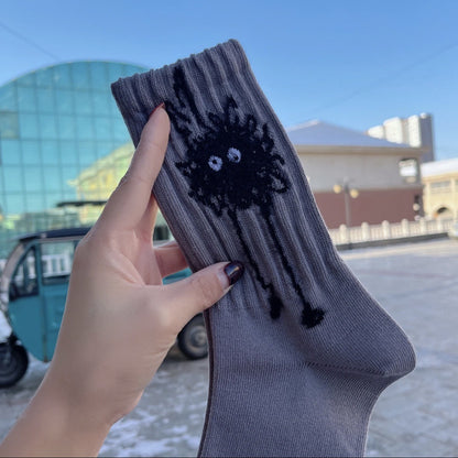Rufia socks worn on feet displaying abstract black and white spots