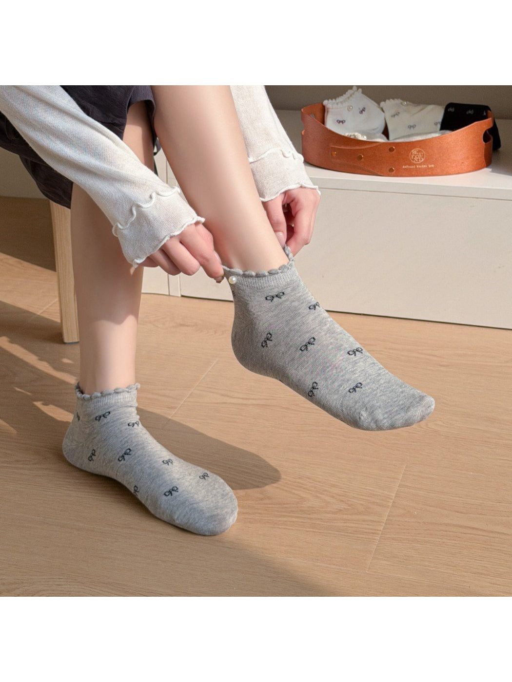 Close-up of Rufia ankle socks showing pink bows and delicate frill trim