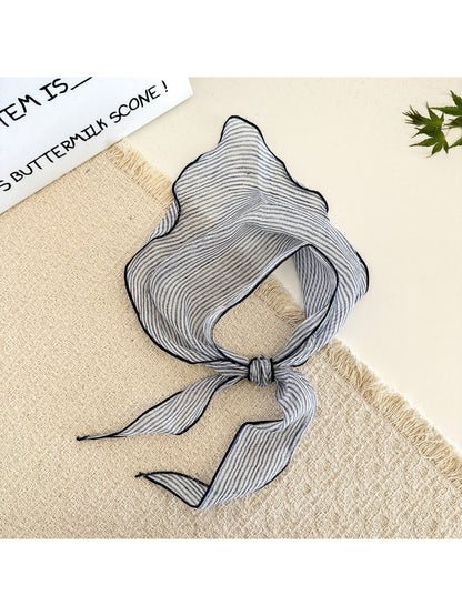 Close-up of soft fabric with horizontal stripes in beige and cream colors