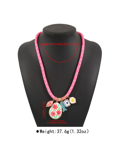 Detailed view of silver charms and multicolored beads on Neckit Mixed Charm Beaded Necklace