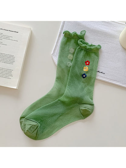 Flat lay of Rufia Sweet Flower Detail Crew Socks displaying full floral embroidery