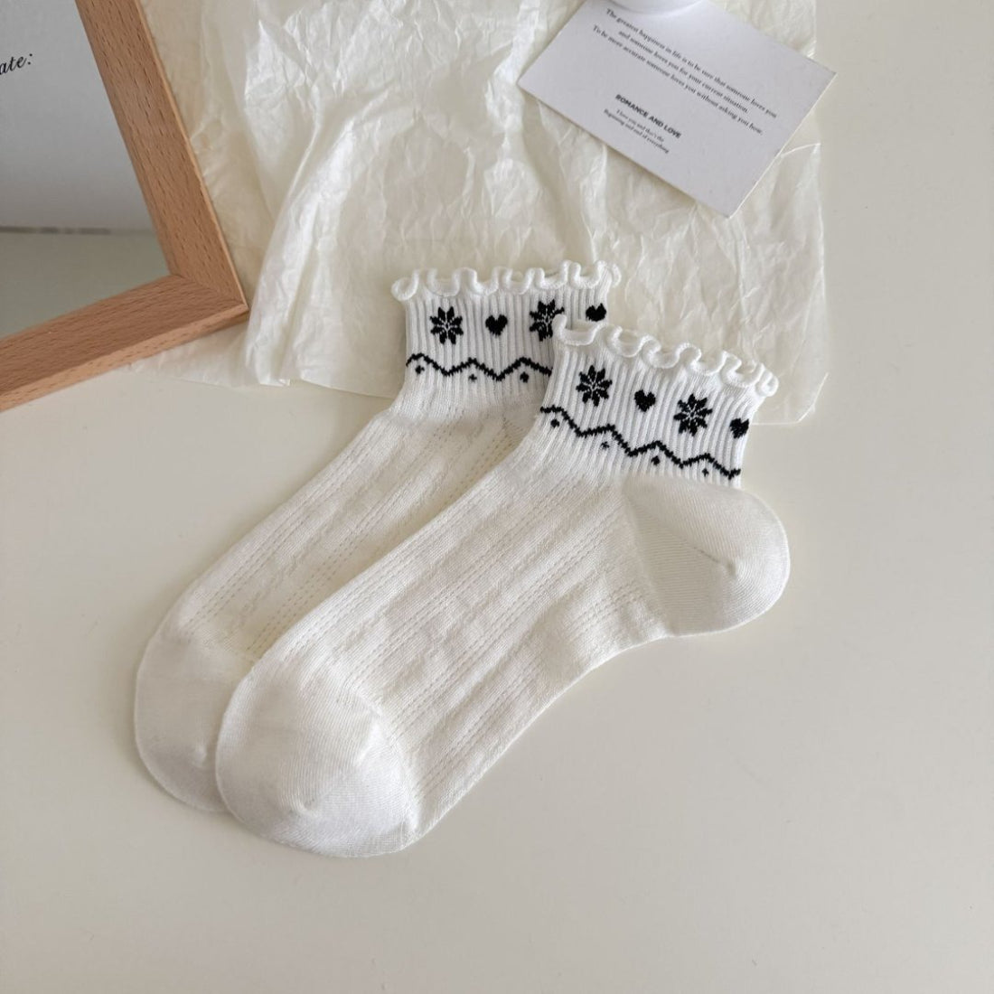 Side view of Rufia Nordic Heart Frill Crew Socks showing ribbed cuff and heart details