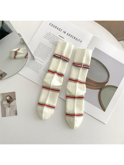 Rufia socks worn with casual shoes highlighting the bold stripe design