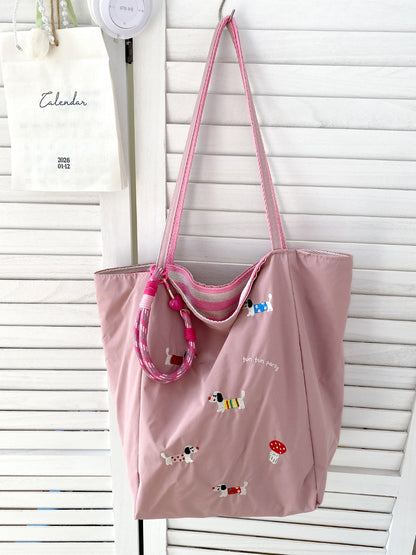 Close-up of tote bag stitching and fabric texture with puppy print