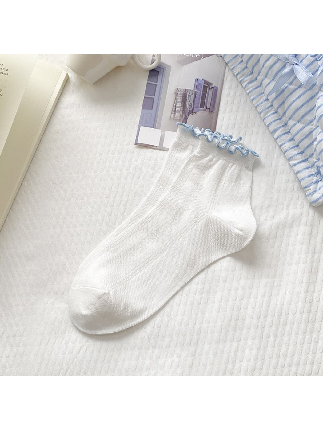 Model wearing Rufia white crew socks with red edge detail and sneakers