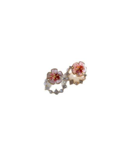 Model wearing Earwish pink flower accent earrings with a soft smile