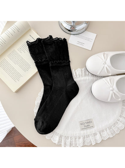 Side view of Rufia scallop edge lace crew socks on a model
