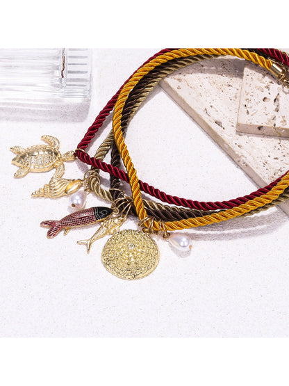 Neckit multi strand rope necklace with ocean charms worn on a model's neck