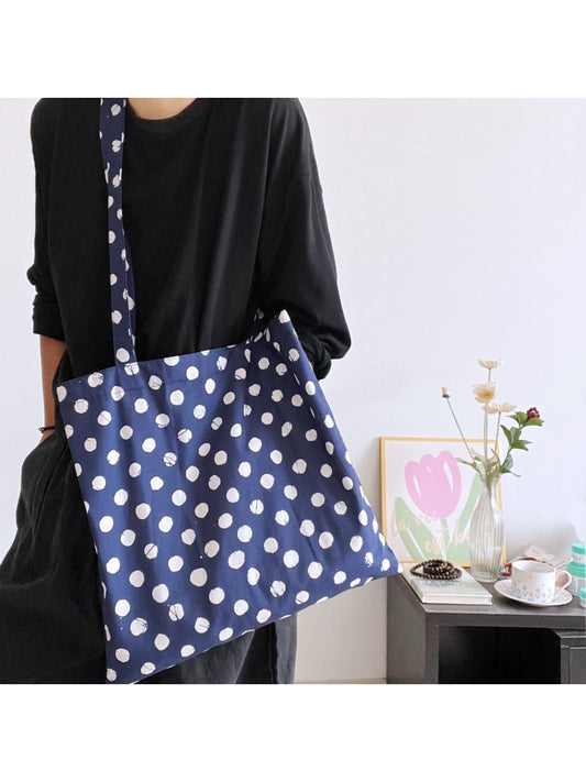 Cosbai navy tote bag with white polka dots and tan handles on white background